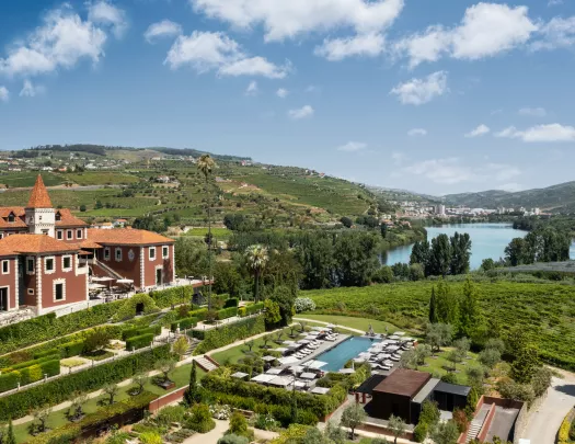 Top view of red building with a garden and outdoor pool in front