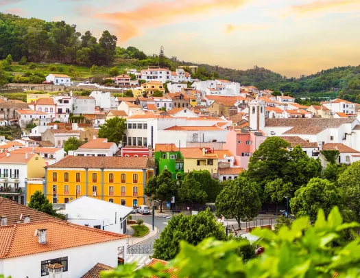 View of houses along a hill with the sunset in the background