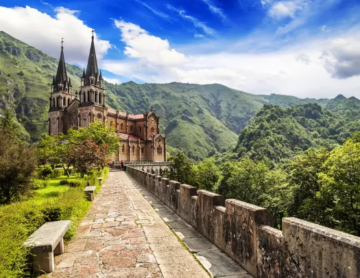 Long brick path leading to a castle-like church building