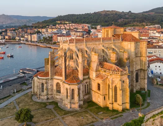Rustic, castle like building with a lake in the background