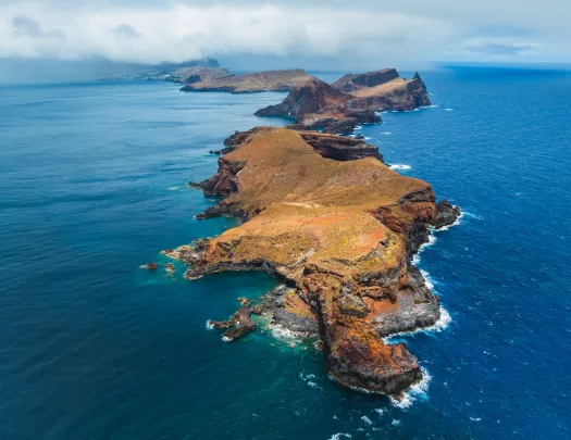Large island with cliffs next to the ocean