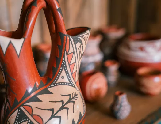 Clay pots and cups on a wooden table