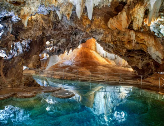 Cave with white crystals and blue water