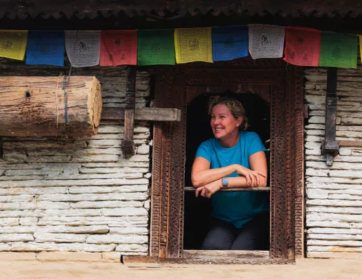 Woman leaning out a window while smiling