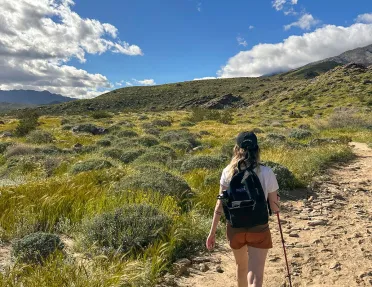 A woman hiking on a dirt path