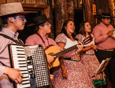 Band playing accordion, guitar and tambourine. 