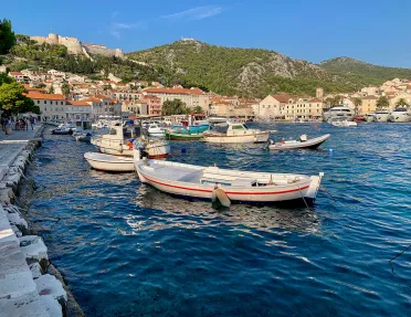Coastal town and houses, boats scattered about.