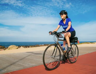 Biker riding on a road along the Douro River.