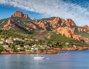Village And Trees Among Red Rocks of Esterel Massif During Sunny Day-French Riviera, Provence-Alpes, Cote d'Azur, France