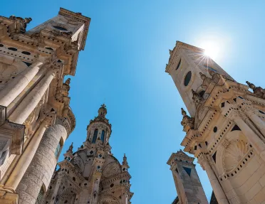 Ground shot looking up at the Château de Chambord spires.