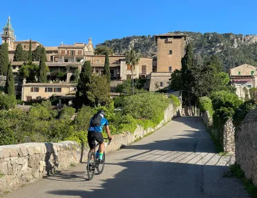Biker riding across a bridge in Spain.