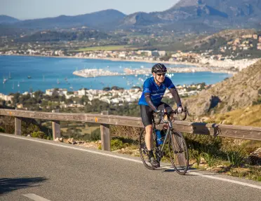 Biker riding along the coast in Menorca.