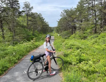 Young guest on small backroad with bike.