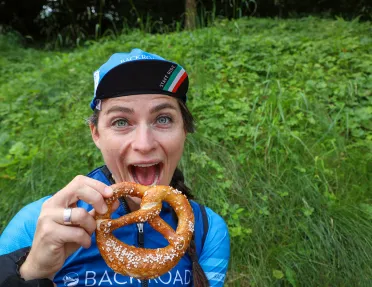 Backroads leader posing with soft pretzel.