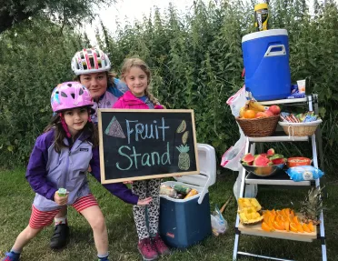 Kids posing at fruit stand snack table