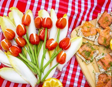 Close-up of food spread, salmon, green beans, peppers, cheese, etc.