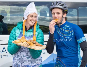 Guest and leader snacking on local food