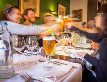 Guests raising a glass at dinner
