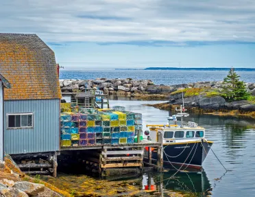 Shot of fishing vessel at port and lobster/crab traps.