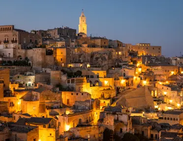 Shot of Matera during sunset, light illuminating city.