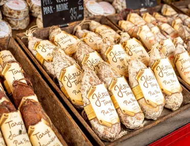 Close-up shot of wrapped cured meats.