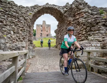 3 Guests Riding Cobblestone Under Old Arch Scotland
