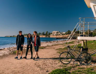 People walking along California beach.