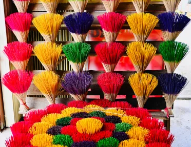 Large array of colorful incense sticks. 