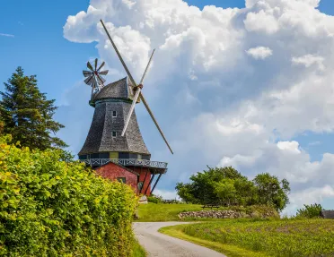 Windmill with dramatic clouds hovering over