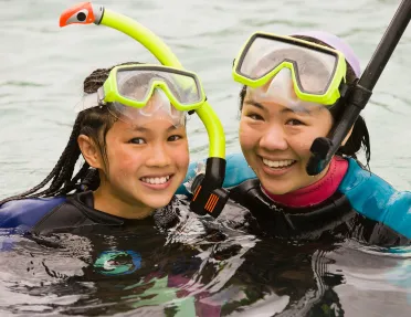 Close-up of two guests in snorkeling gear.