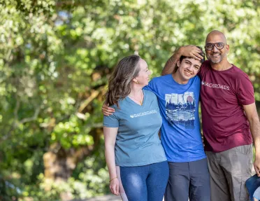 Three Backroads guests hugging, posing for photo.