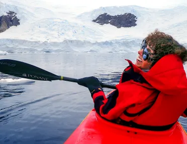 Person kayaking in the icy waters of Antarctica