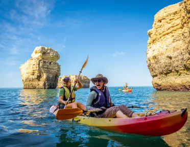 Kayaking among towering rocks in Portugal