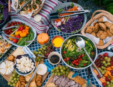 Large lunch spread, salads, veggies, cheeses, cookies, etc.
