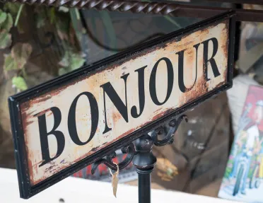 Rustic sign reading "BONJOUR".