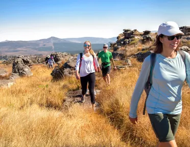 Hikers smiling along trail in Africa