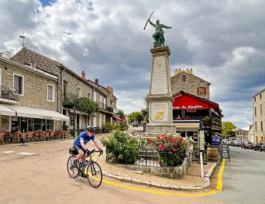 Guest cycling through town square in Zonza.