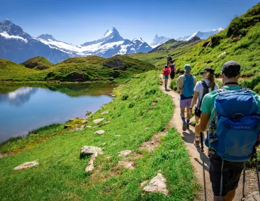 Group of guests walking past Bachalpsee Lake,