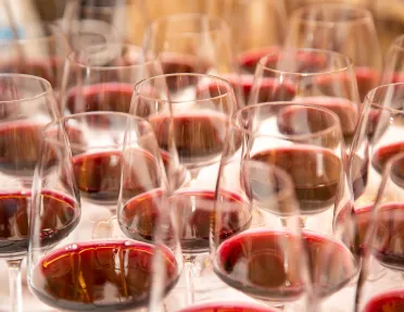 Numerous glasses of red wine.