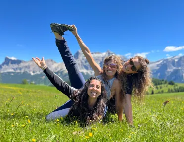 Three guests in a grassy field, posing for camera.