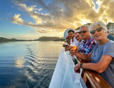 Looking out over the side of a boat in Tahiti at sunset