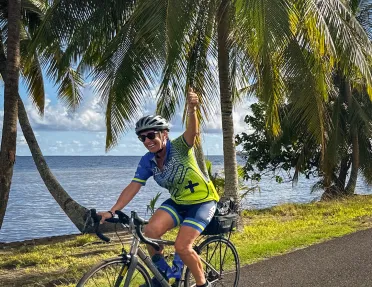 Biking along a palm tree lined shore in Tahiti