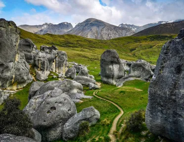 Winding path among large rocks and boulders in New Zealand
