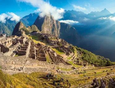 Bird's eye shot of Machu Picchu, large group of people in foreground.