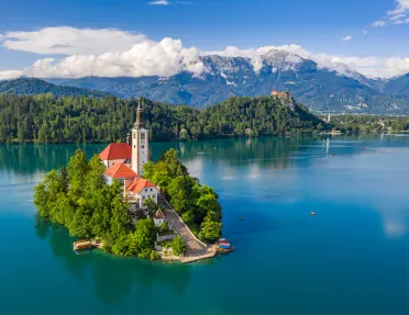Church on island in center of blue lake.