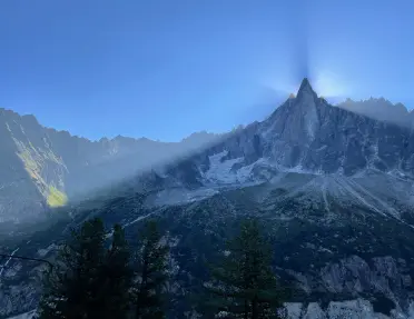 Shot of large mountain eclipsing sun, camera is in shadow.