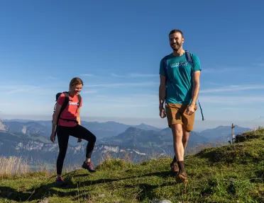 Two hikers on top of a hill. 
