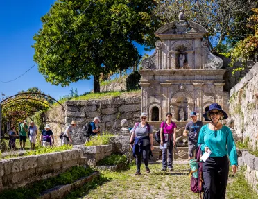 Guests walking among hilly stone ruins.