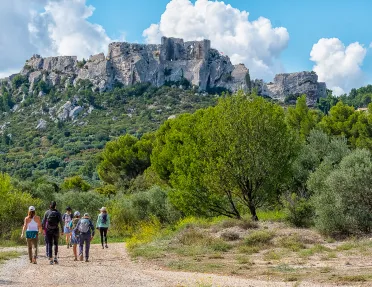 Backroads Guests Walking Towards Rock Formation in Mountain