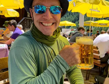 Guest smiling at camera, beer in hand.
